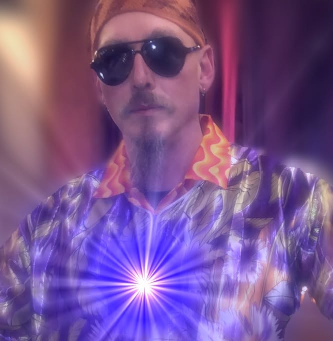 Tomi wearing sunglasses and a patterned shirt, surrounded by colourful light effects.