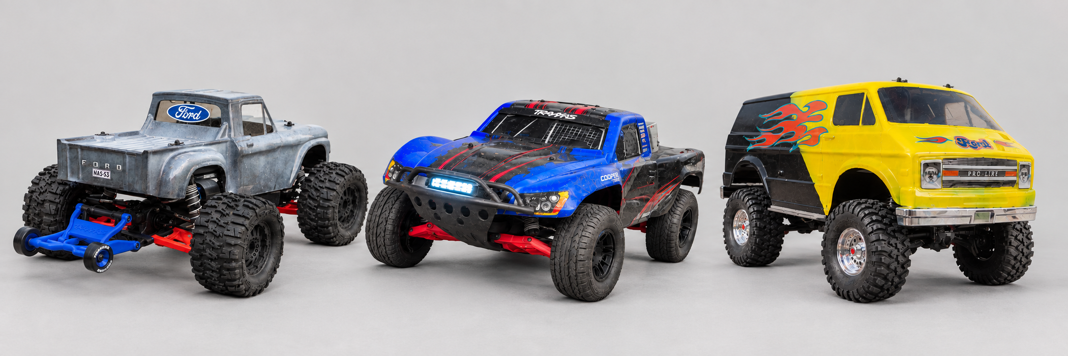 My Traxxas Stampede 4WD, Slash 2WD and TRX-4 "Rock van" arranged against a plain light-gray background.